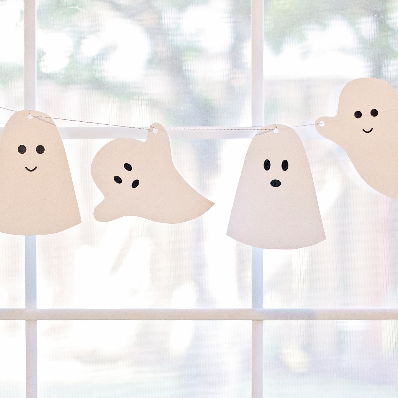 Printable ghost banner hanging on a white shelf
